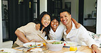 Portrait, family dinner and child hug parents in home, holiday bonding and sharing meal together. Happy people, healthy food or girl with embrace for connection, nutrition and support at dining table