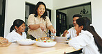 Family lunch, children and woman cutting in dining room, holiday meal and healthy food for nutrition. Laughing, parents and girls by table in home, eating together and bonding for happy relationship