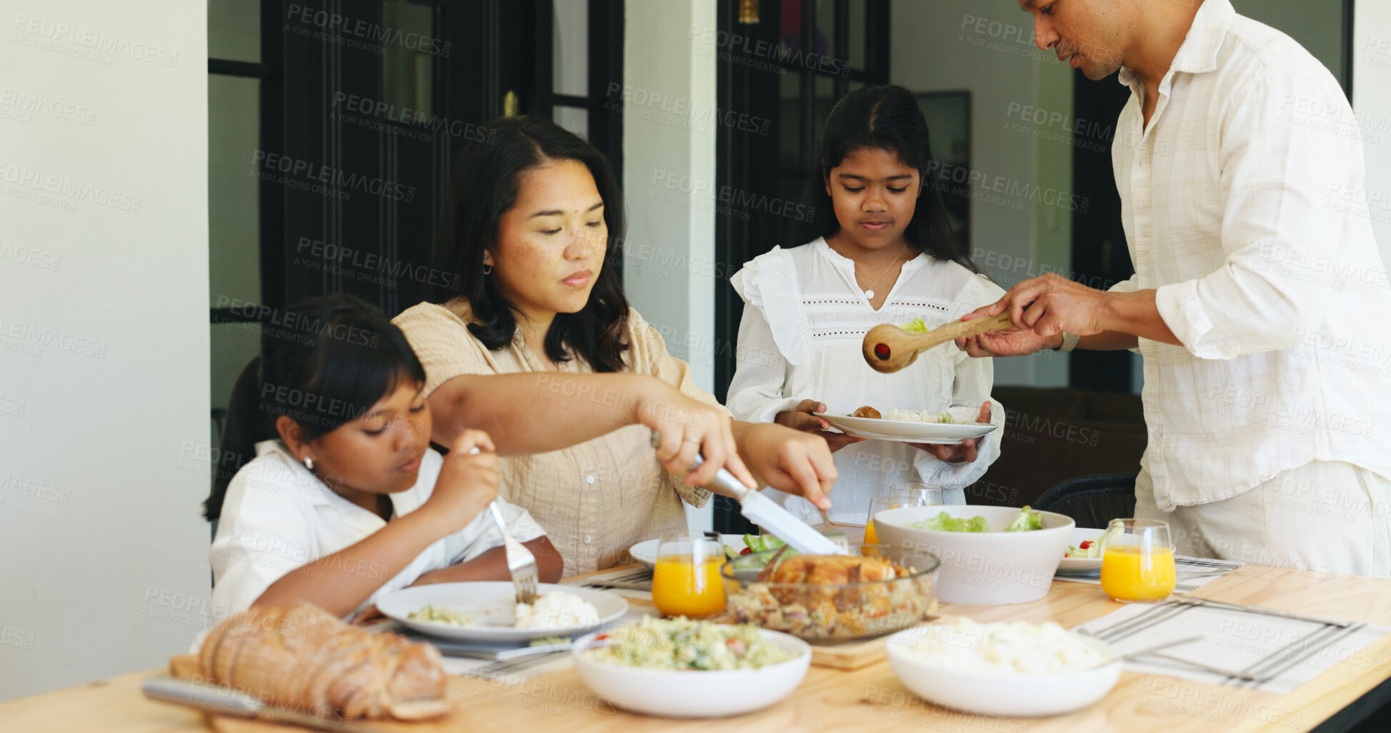 Buy stock photo Family dinner, children and woman cutting in dining room, holiday weekend and serving food for meal time. Hungry, parents and girls at table in home for healthy supper, eating together and bonding
