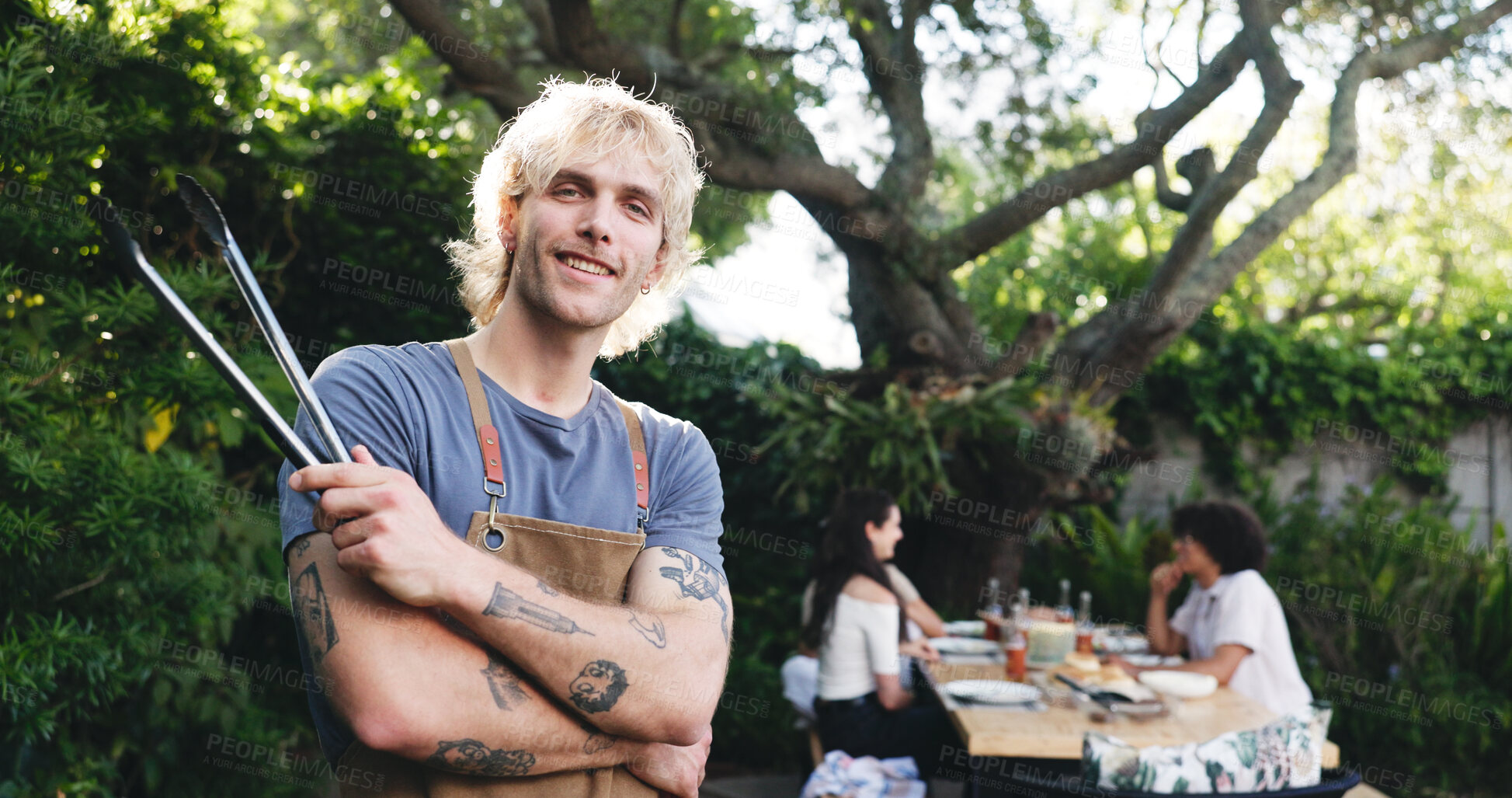 Buy stock photo Man, portrait and tongs in backyard for barbecue at house for reunion with confident cook outdoor. Arms crossed, smile and male person with utensil for BBQ, summer holiday and cookout with friends