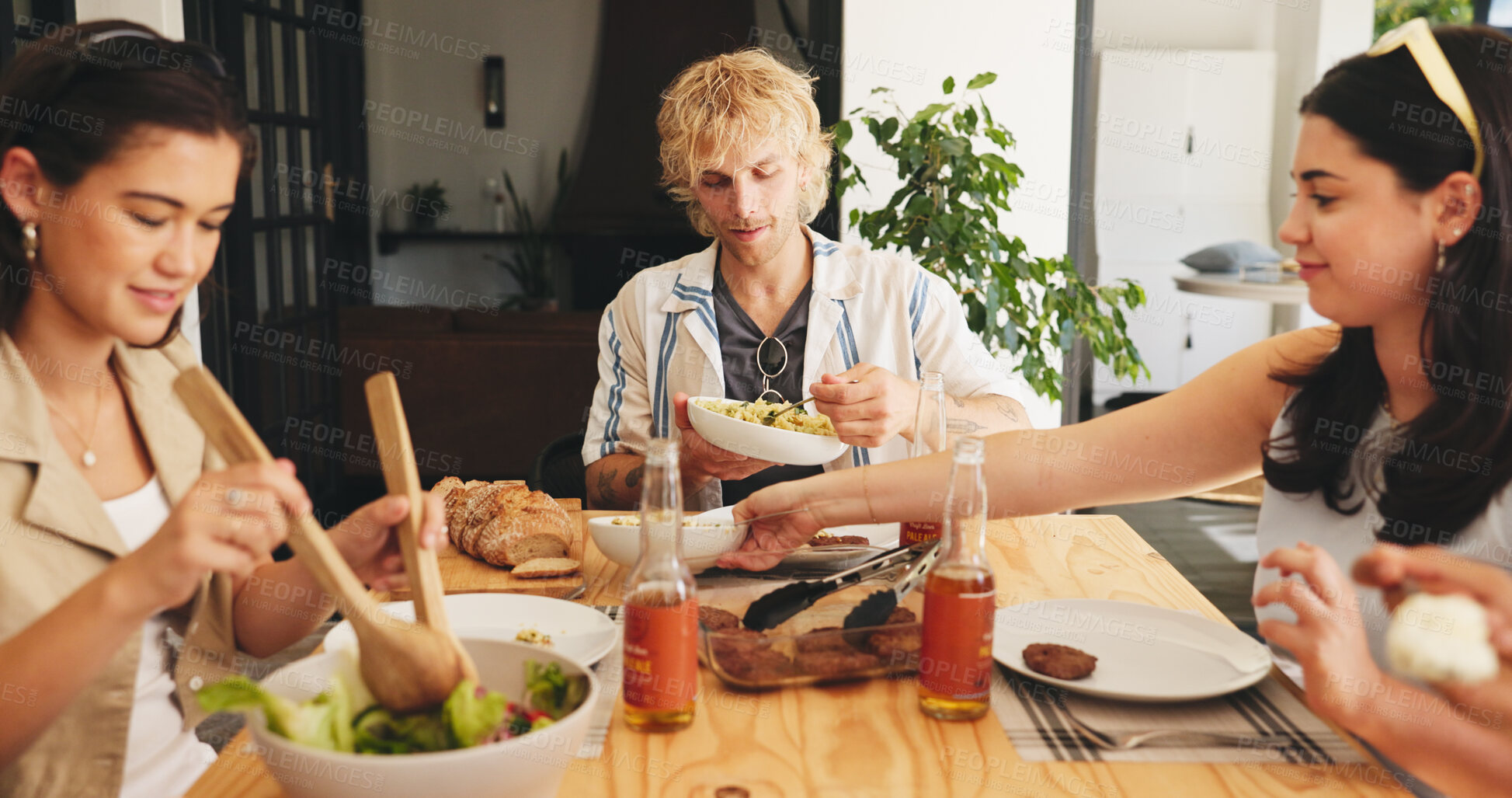 Buy stock photo Lunch, eating and relax with friends in house for food, social reunion and summer vacation. Gathering, party event and group of people in dining room of apartment for holiday, hungry and support