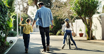 Buy stock photo Father, children and holding hands in street with walk, bicycle and activity for bonding together. Back, dad and kids stroll outdoor in neighborhood with support, bike and care for family connection.