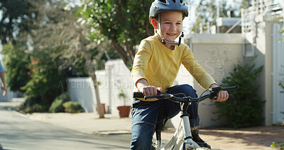 Buy stock photo Road, happy and child on bicycle in neighborhood for learning, adventure and cycling outdoor. Smile, weekend and boy on bike with safety gear for ride, fun hobby and active on holiday or vacation 