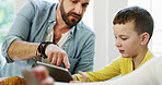 Tablet, father and child in home for app, bonding together and pointing for movie choice with family. Boy, dad and tech in house for website, online film or check cartoon with parent at breakfast