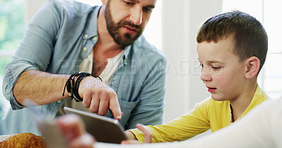 Buy stock photo Tablet, father and child in home for app, bonding together and pointing for movie choice with family. Boy, dad and tech in house for website, online film or check cartoon with parent at breakfast