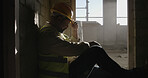 Construction site, thinking or man with safety, relax or maintenance with planning. Break, person or inspection with  urban development, choice or solution with helmet, problem solving or engineering