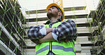 Construction site, looking up and man with inspection, arms crossed and below with planning. Person, engineering and employee in city, real estate and helmet for safety, ideas or architecture project