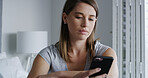 Woman, phone and sad in bedroom with texting, notification and online dating chat at apartment. Person with depression, smartphone and bad news on mobile app, contact or post on social media in home