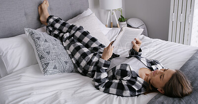 Buy stock photo Woman, reading book and lying on bed in home, relax and pyjamas for story, smile or rest with novel. Person, happy and break with literature, fiction and fantasy with language in morning at apartment