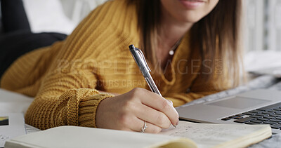 Buy stock photo Hands, student and writing in book on bed, home and online course with notes, study and scholarship. Person, computer and journal with assessment, elearning or education with virtual college project