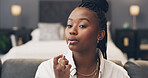 Black woman, makeup and influencer in home, lipstick or product with beauty tutorial, chat or opinion on web. African person, review and cosmetics with lip gloss, application or social media in house