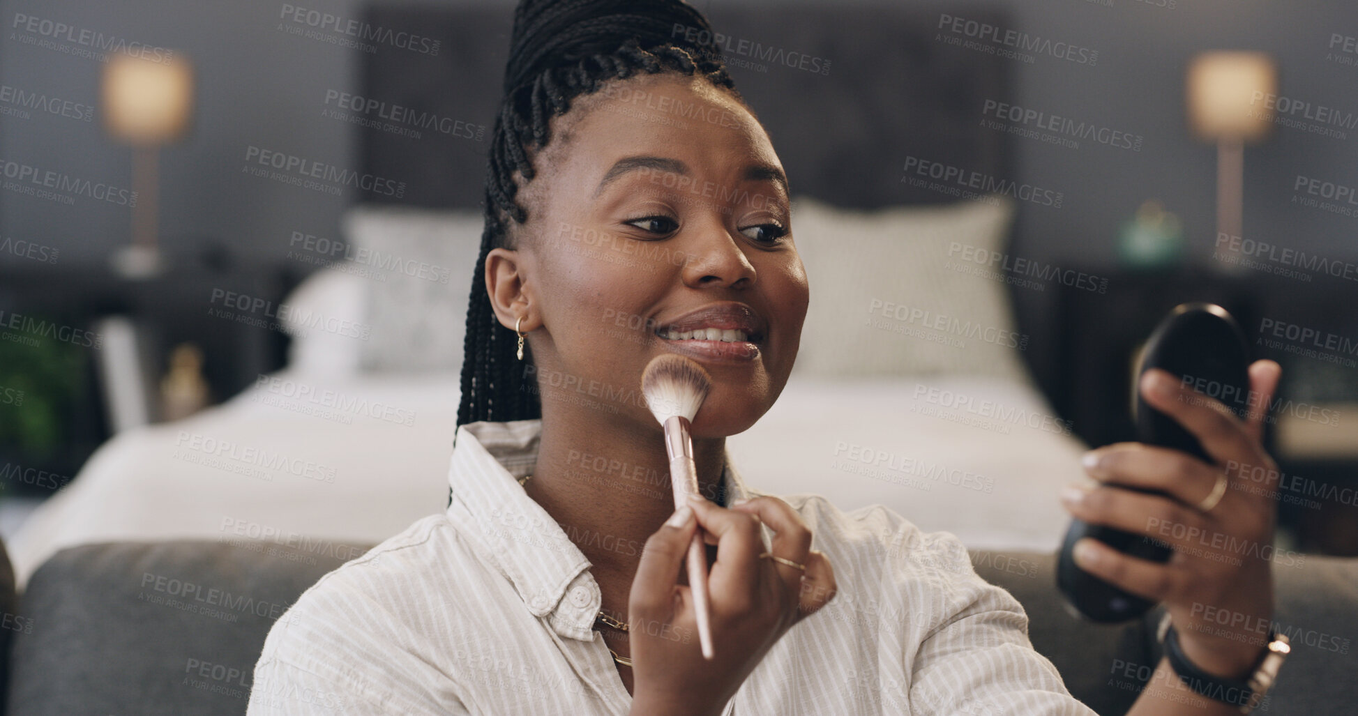 Buy stock photo Black woman, mirror and makeup brush in bedroom with smile, foundation or concealer at apartment. African person, beauty and cosmetics for facial transformation, powder and morning routine at house