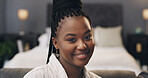 Black woman, smile and relax on sofa in portrait, pride and confidence in bedroom at apartment. African person, happy and rest on couch, chill or cozy for comfort on break at house in Nigeria
