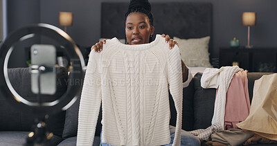 Buy stock photo Content creator, ring light and black woman with clothes in home for talking, product review and opinion. Influencer, bedroom and person with fashion advice, feedback and live streaming for promo
