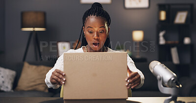 Buy stock photo Content creator, surprise and black woman with box in home for recording, unboxing and product review. Influencer, live streaming and person with package, parcel and opening for social media podcast