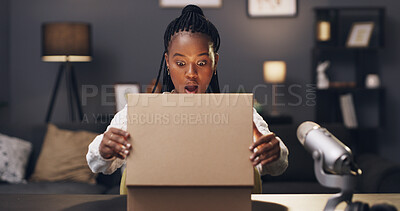 Buy stock photo Influencer, surprise and black woman with box in home for recording, unboxing and product review. Content creator, live streaming and person with package, parcel and opening for social media podcast