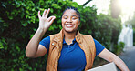 Happy, delivery service and portrait of black woman outdoor with box for approval with cargo export. Smile, package and African person with ok hand gesture for distribution, courier or logistics.