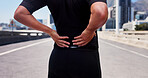 City, hands and athlete with backache, hurt and training accident on urban road, sore or joint pain. Outdoor, fitness and person with bad posture, inflammation and workout mistake on street or injury