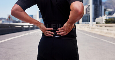 Buy stock photo City, hands and athlete with backache, hurt and training accident on urban road, sore or joint pain. Outdoor, fitness and person with bad posture, inflammation and workout mistake on street or injury