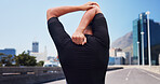 Man, runner and stretching in city with arms, back and blue sky for training, warm up and circulation. Person, outdoor and ready for fitness, exercise and cardio challenge on bridge in urban town