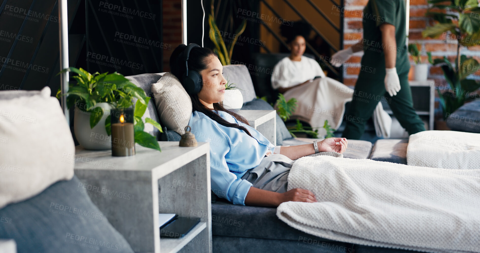 Buy stock photo Woman, relax and headphones in drip lounge, healthcare and listening to music for medical treatment. Clinic, recovery and person with tech for audio, immune system boost and iv nutrients for wellness