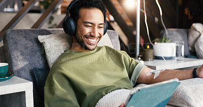 Buy stock photo Headphones, man and tablet with IV drip in lounge for nutrients, recovery or streaming app. Relax, happy patient and tech with Intravenous fluid for health benefits, mineral infusion and funny video