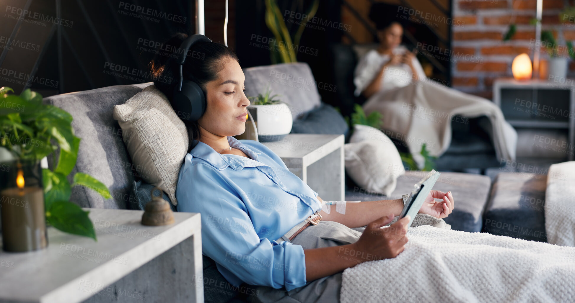 Buy stock photo Woman, tablet and headphones with IV drip for healthcare, infusion treatment and streaming video. Patient, tech and relax in medical lounge for immune booster, hydration therapy and social media