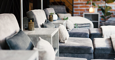 Buy stock photo Interior, lounge chair and wellness clinic for comfort, ambiance and peace in empty treatment room. Minimalist aesthetic, cozy or luxury sofa for calm spa experience with candles, textures or design