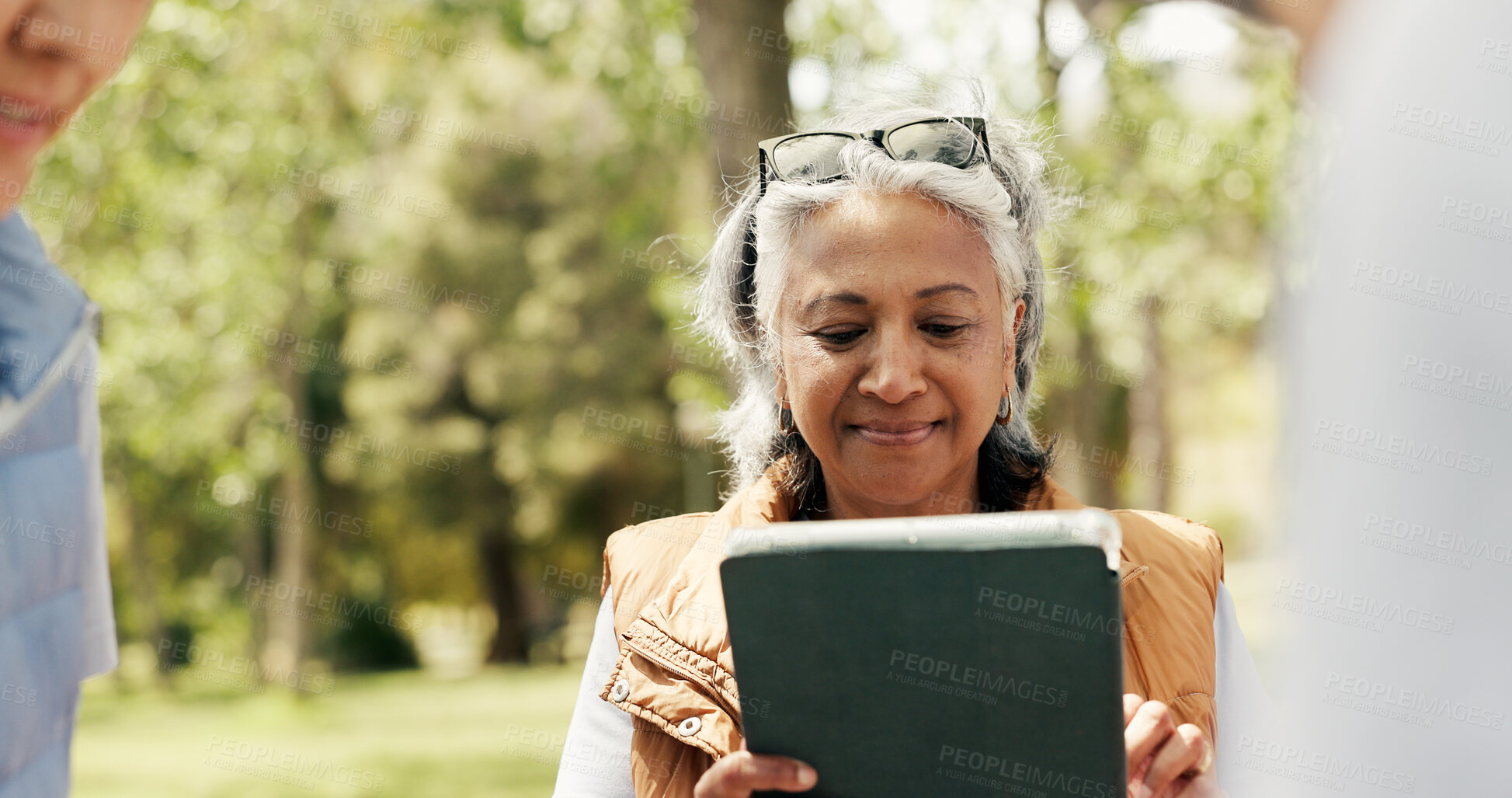 Buy stock photo Mature woman, volunteer and tablet outdoor for charity, online checklist and community service. Group, people and digital for donation inventory, humanitarian outreach and reading schedule for event