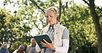 Woman, volunteer and reading with tablet at park for charity, online checklist and community service. Below, person or digital for donation inventory, humanitarian outreach and non profit for project