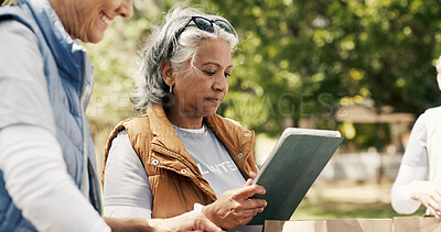 Buy stock photo Woman, volunteer and reading with tablet outdoor for charity, checklist and community service. Mature person, digital and donation inventory for food drive, humanitarian outreach and event schedule