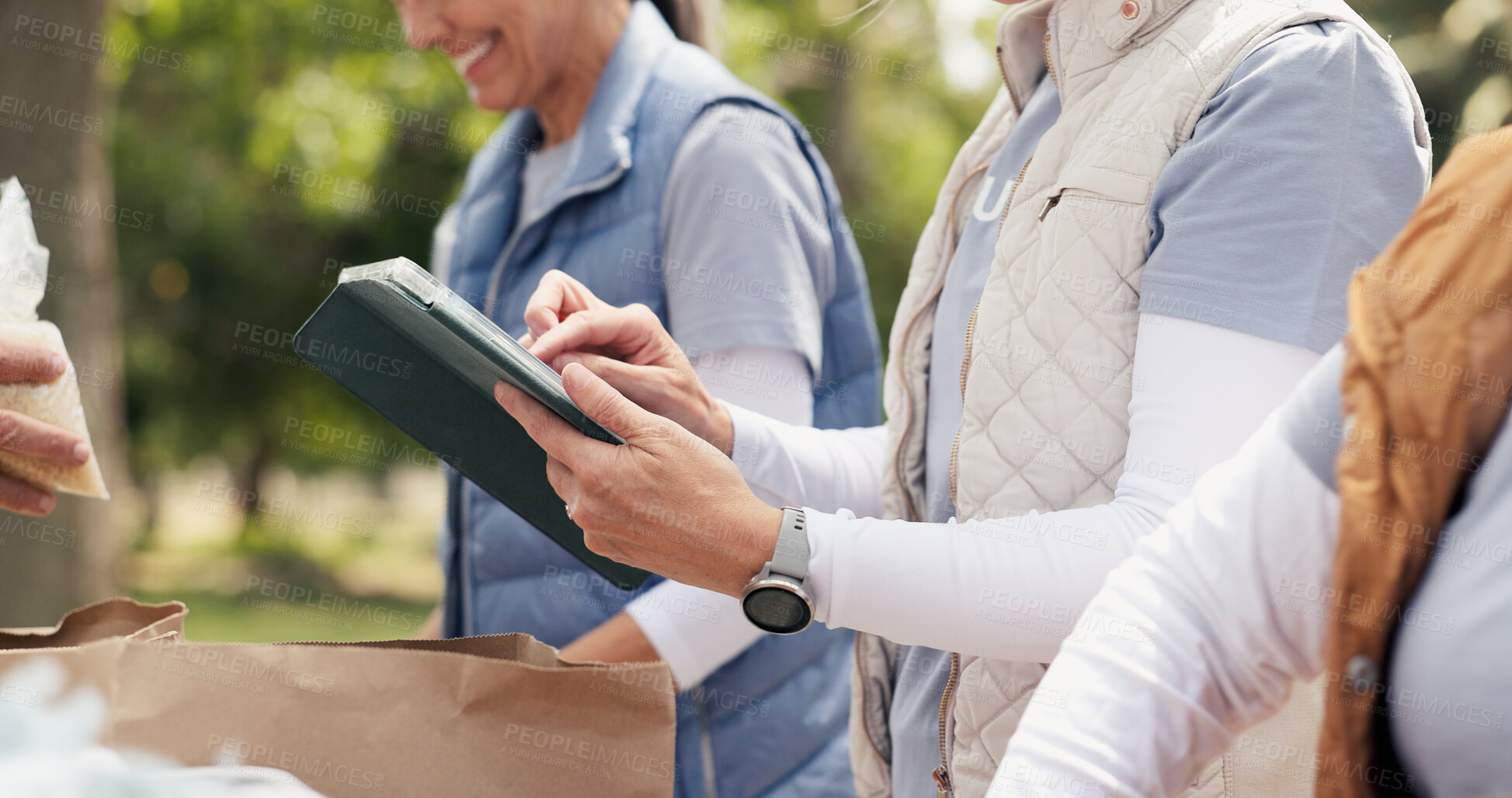Buy stock photo Hands, person and typing on tablet outdoor for charity, online checklist and community service. People, parcel and digital for donation inventory, humanitarian outreach and ngo schedule of food drive