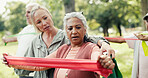 Resistance band, coach and senior people in nature for exercise class with stretching. Fitness, equipment and group of elderly friends with personal trainer for arm workout with wellness in park.