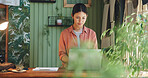 Research, laptop and plant with woman in store for delivery checklist, email or botany review. Order confirmation, sustainability and entrepreneur with person and tech in eco friendly small business
