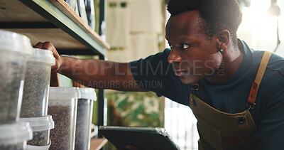 Buy stock photo Black man, tablet and stock in nursery with checklist, inventory management or online order. Entrepreneur, sustainable business and tech at shelf for compost storage, soil quantity or quality control