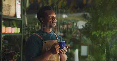 Buy stock photo Relax, coffee and nursery with black man in store for calm, environment and sustainability. Entrepreneur, caffeine beverage and peace with person and breathing in shop for drinking herbal tea