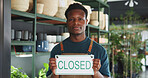 Closed sign, portrait and nursery with black man in store for announcement, eco friendly shop and signage. Environment, small business and entrance with person for storefront, retail and notice board