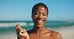 Happy woman, travel and heart fingers on beach for vacation, environmental care and freedom. Black person, excited and love emoji at ocean for summer holiday, wellness or nature appreciation on coast