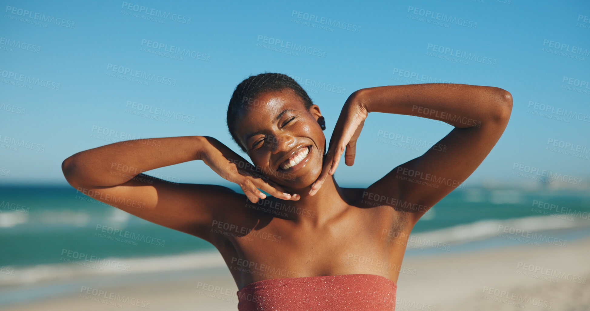 Buy stock photo Black woman, excited and skincare on beach for travel, sun protection and hand frame on vacation. Person, dermatology and happy at ocean for summer holiday, SPF benefits and confident with freedom