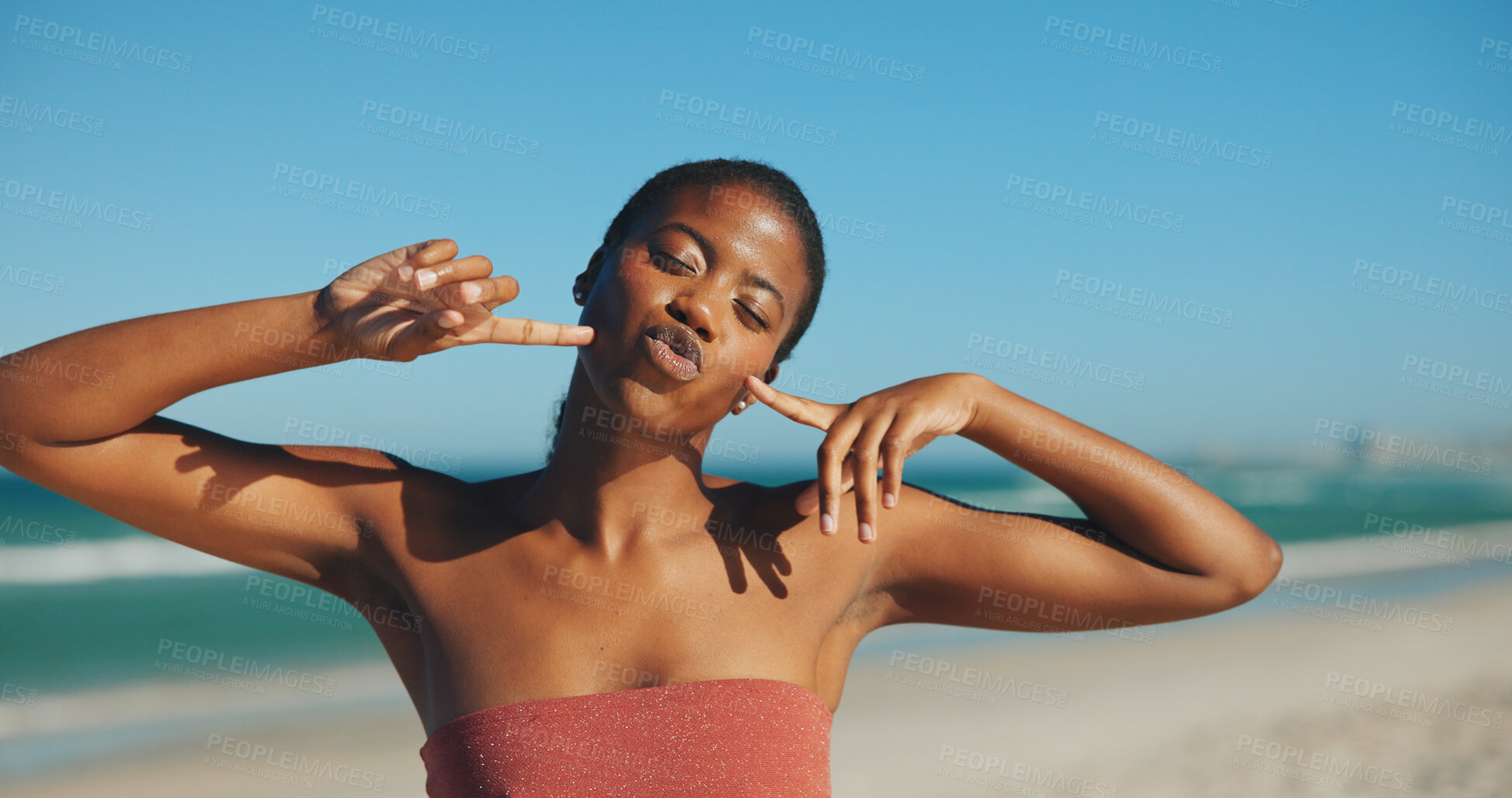 Buy stock photo Black woman, pout and skincare on beach for travel, sun protection and gesture on vacation. Person, dermatology and happy at ocean for summer holiday, SPF benefits and blowing kiss with confidence