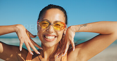 Buy stock photo Woman, excited and sunglasses on beach for travel, sun protection and hand frame on vacation. Female person, manicure and happy at ocean for summer holiday, UV eyewear and confident in portrait