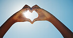 Person, outdoor and heart hands in sunshine for travel, blue sky and summer vacation. Tourist, love emoji and lens flare in nature space for holiday, environmental care and low angle in paradise