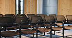 Chairs, seminar and empty room for business forum, event and convention or meeting venue. Furniture, hall and interior of conference center with rows for summit, presentation or seats for workshop