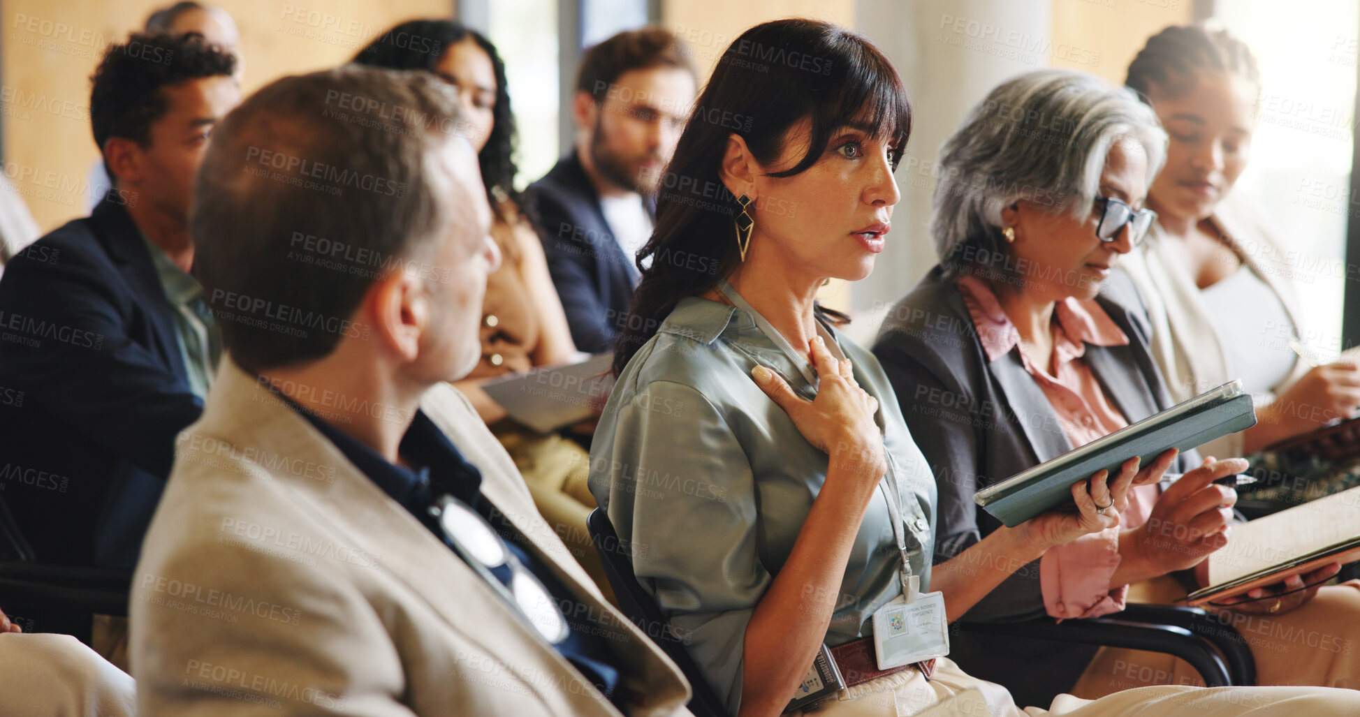 Buy stock photo Business woman, tablet and convention with group for corporate training, explain or respond at conference. Executive talking, tech and feedback with insight for professional development at seminar