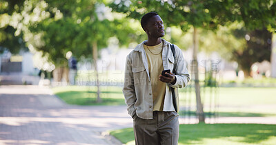 Buy stock photo Black man, walking and thinking in park with smartphone for communication or post ideas for social media on commute. Person, phone and space for reflection on stroll outdoor for travel with chat app