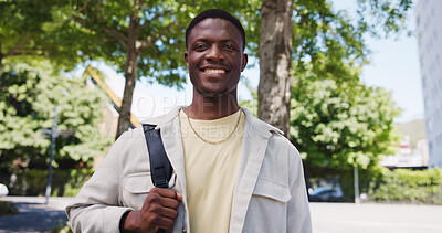 Buy stock photo Black man, portrait and smile in city with low angle, space and positive for learning, scholarship or academics. Person, student and college pride with growth or development for education outdoor