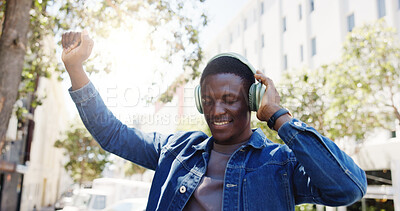 Buy stock photo Black man, student and dancing in city with headphones, favorite song or rhythm on morning commute. Person, college academic or streaming music in town with energy, travel or positive for scholarship