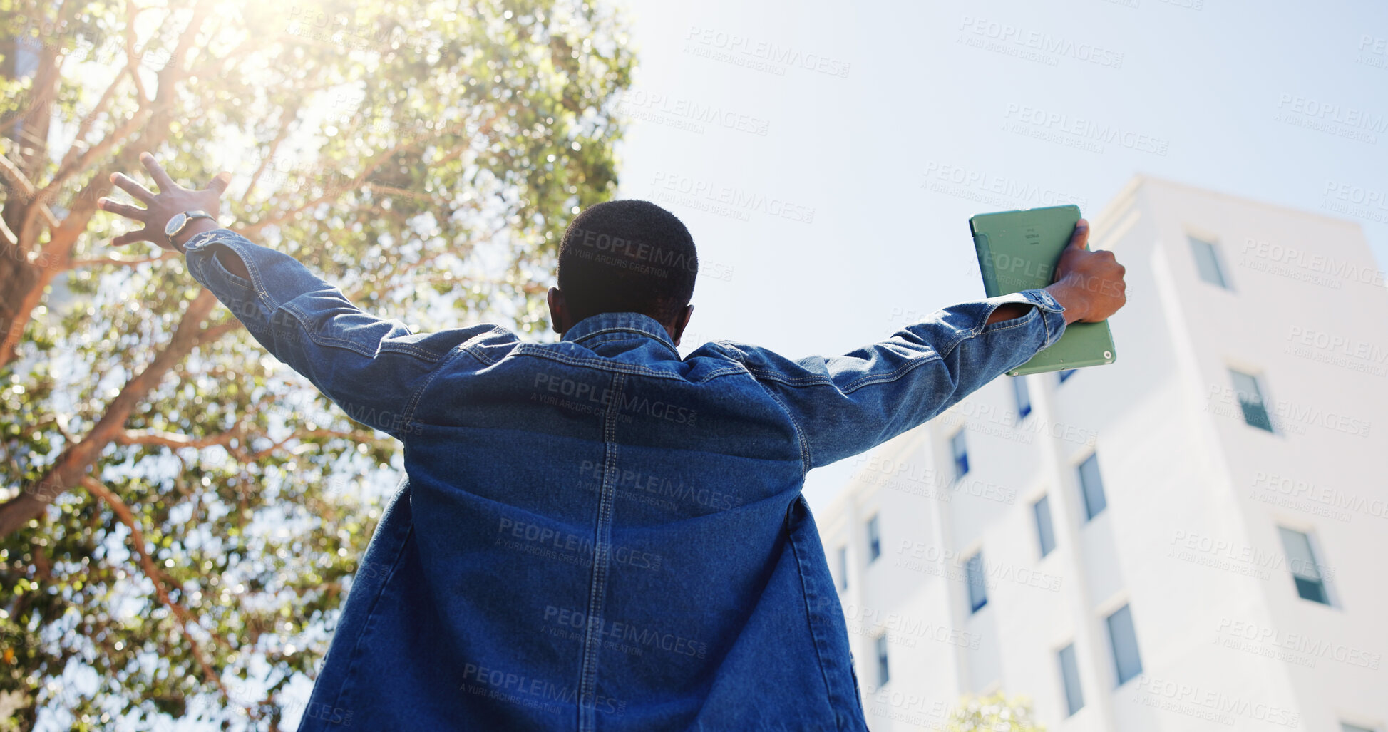 Buy stock photo Man, student and tablet in city with freedom, academic achievement or scholarship opportunity. Back, low angle or person outdoor with tech for university acceptance, success or funding grant to study