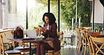 Phone, laptop and freelancer with woman in cafe for hospitality blog, food review and research. Remote worker, online report and restaurant critic with person in coffee shop for reading and web log