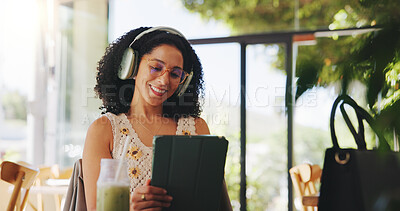 Buy stock photo Happy woman, headphones and tablet in cafe for scroll, audiobook or check online university portal. Student, tech for learning platform or reading with drink or listen to podcast at college cafeteria